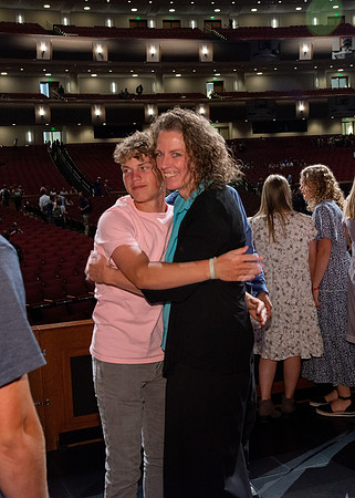 Sister Heather Hall huging her family after devotional.