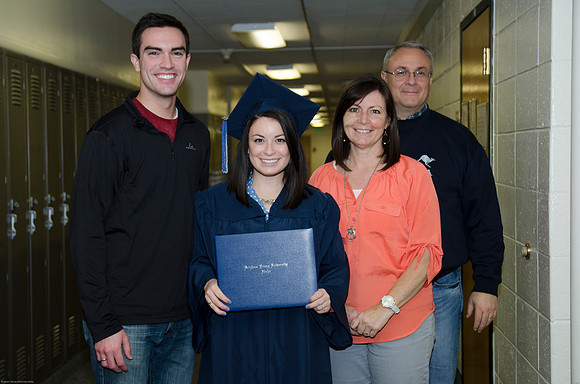 AImee Edmonds gathers with her family after receiving her diploma.