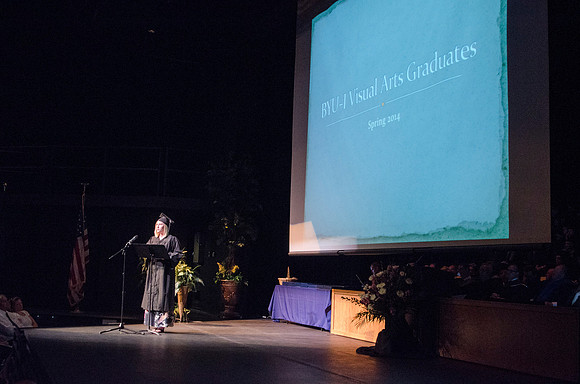 Clairissa Shaw, Bachelor of Fine Arts with an emphasis in Two-Dimensional Studies, gives a visual arts presentation during convocation in the Snow Building. Photo by Tyler Rickenbach