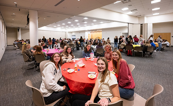 Taylor building room 160 and 170 set up with round tables for a Stake Relief Society Social.