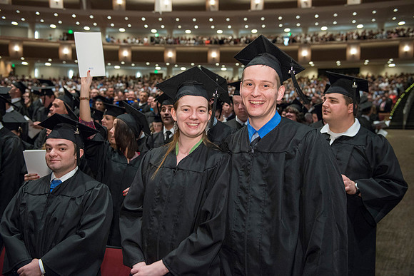 Graduates gather and march in during the processional for April 2014 Graduation ceremonies in the BYU-Idaho Center.
