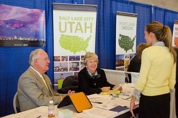BYU-Idaho students speak to representatives from colleges or companies from their field of study at a career fair held in the I-Center gym