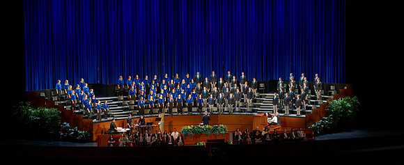 Women and men choir performing during devotional.