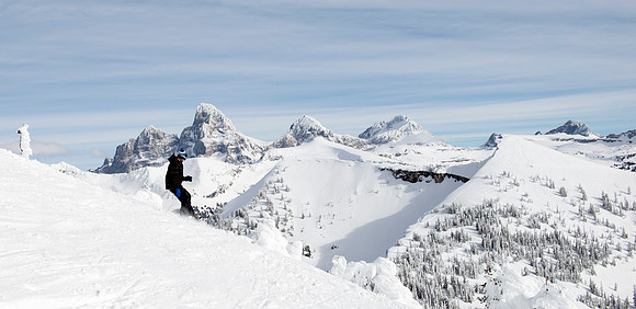BYU-Idaho students taking a snowboarding class, snowboard with the Tetons in the background.