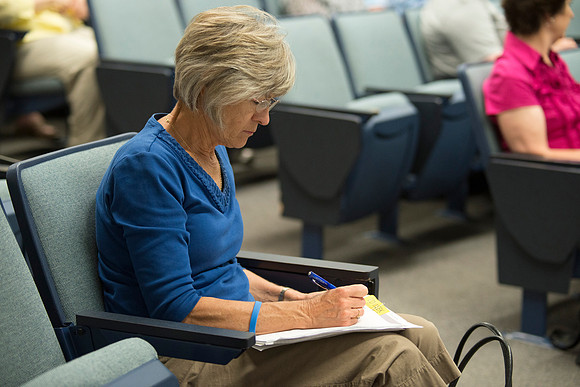 Adult participants listen to a class presented by Phil Packer.