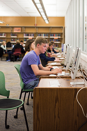 Students prepare for their classes, in the McKay Library.