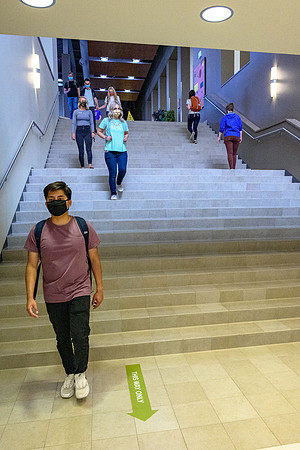 Student volunteers show the way to stay safe during this COVID 19 pandemic by social distancing, following pathway arrows and proper wearing of masks .