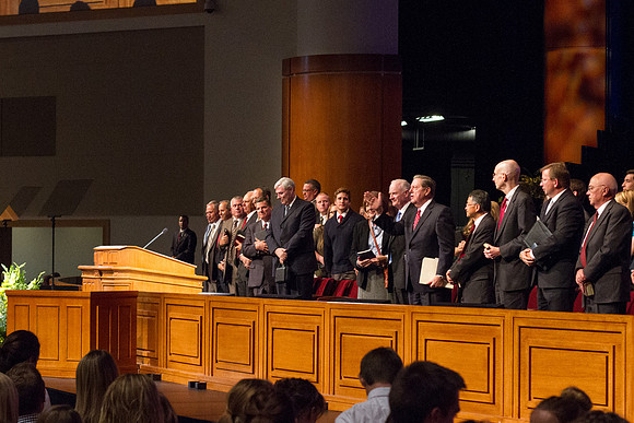 Elder Holland waves goodbye to the students and faculty as Devotional ends.