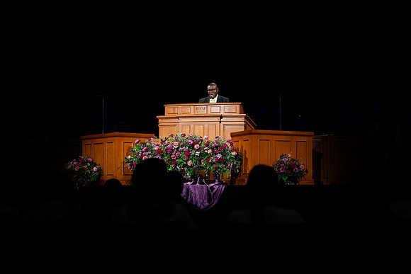 Elder Egbo speaking to students in the BYUI Center.