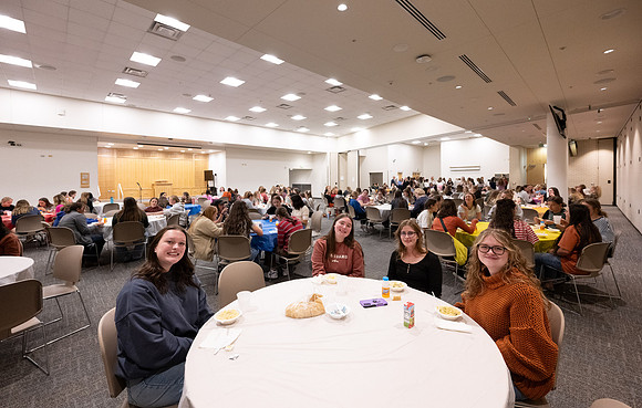 Taylor building room 160 and 170 set up with round tables for a Stake Relief Society Social.