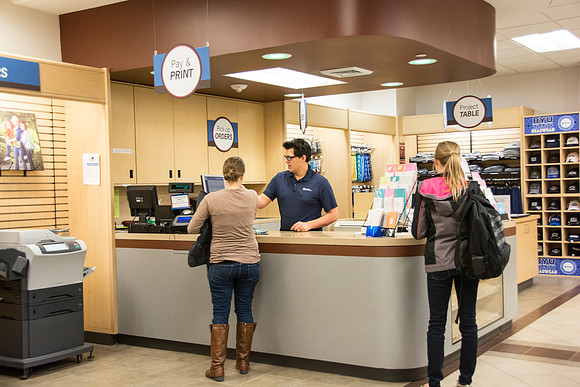 Costumers being helped at service desks.