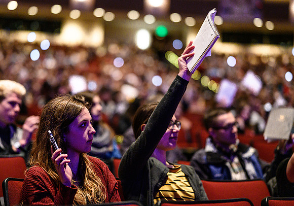 Students show they are ready to learn during devotional, held in the BYU-Idaho Center.
