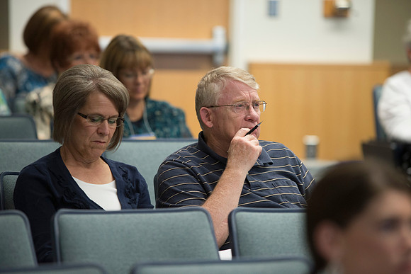 Adult participants listen to a class presented by Phil Packer.