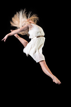 A dance student strikes a pose on the stage.