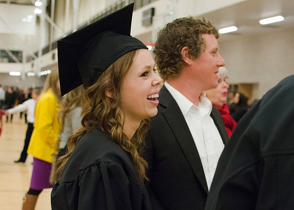 BYU-Idaho Graduate laughs with her friends and family after commencement.