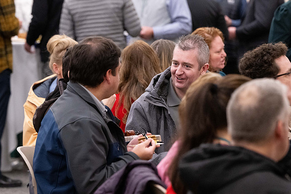 Employees gather for the annual Christmas gathering with President and Sister Meredith.