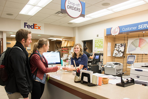 Costumers being helped at service desks.
