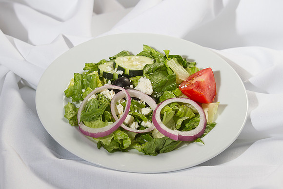 Crisp mixed greens garnished with tomato wedges, cool cucumbers, red onions, feta cheese, and kalamata olives. Topped with a Greek salad dress- ing.