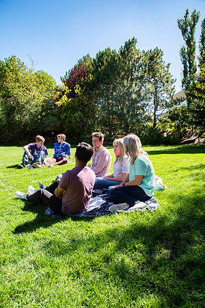 Examples of students staying safe and healthy during the COVID-19 pandemic by social distancing, following pathway arrows, and wearing face masks.