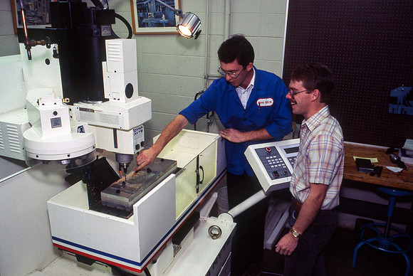 Teacher and Student work alonside one another with Manufacturing Technology. December 1990.