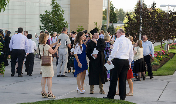 Graduates meet outside on the BYU-Idaho campus after commencement to take pictures before convocation starts.