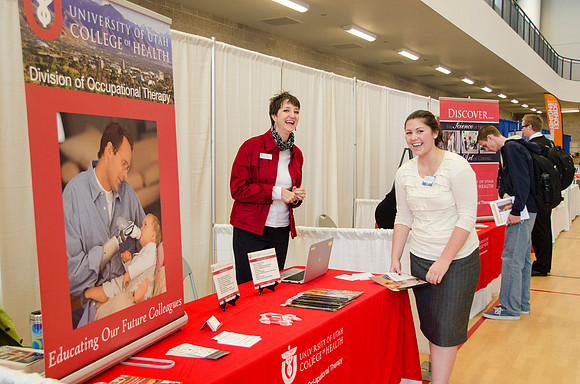 BYU-Idaho students speak to representatives from colleges or companies from their field of study at a career fair held in the I-Center gym
