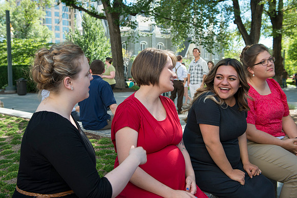 Students of Brigham Young University-Idaho's orchestra and choir socializing on the grounds of Temple Square before performing in the Sacred Music conert. Photo by Ryan Chase