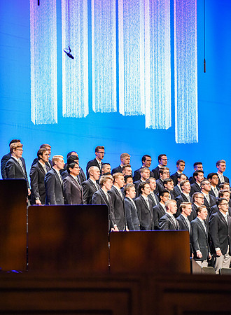 The Men's Choir performs a musical number during devotional, held in the BYU-Idaho Center.