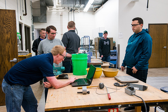 Civil engineering students work with different mixtures of cement to make a light, yet durable, cement that will be the building material for a canoe.