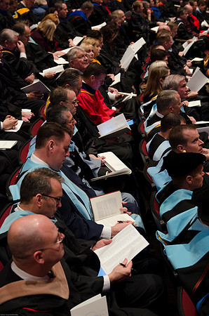 Faculty and Students sit at Graduation Commencement Ceremony.
