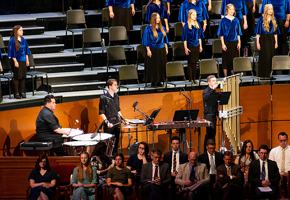 Women and men choir performing during devotional.
