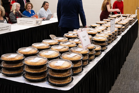 Employees gather for the annual Christmas gathering with President and Sister Meredith.