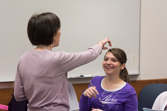 A student laughs at a comment that Sister Glenn made during class.
