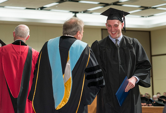 College of Language and Letters Convocation in the Manwaring Center Ballroom. Dean, John Ivers congratulates the graduates.