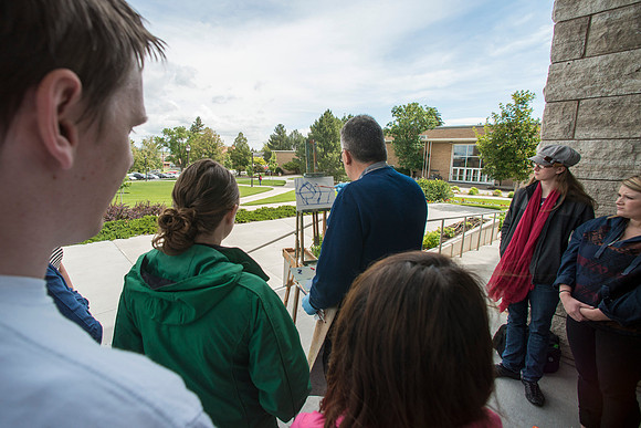 Brother Bodily gives a painting demonstration during his Oil Painting class outside the Spori Building.