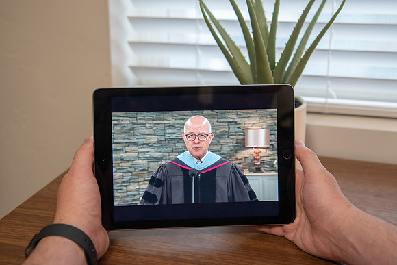 A BYU-Idaho Student watching Elder Clayton during the Spring Graduation Live Stream