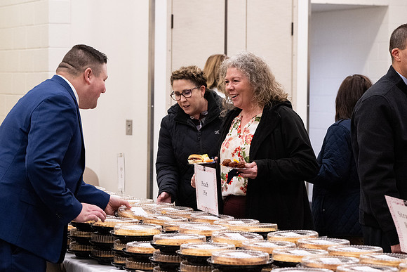 Employees gather for the annual Christmas gathering with President and Sister Meredith.