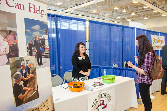 BYU-Idaho students speak to representatives from colleges or companies from their field of study at a career fair held in the I-Center gym