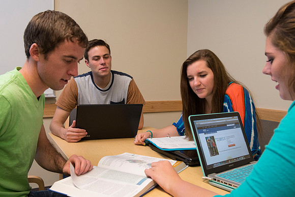 Students engage in an active study group for the new housing promo pictures.