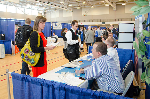 BYU-Idaho students speak to representatives from colleges or companies from their field of study at a career fair held in the I-Center gym