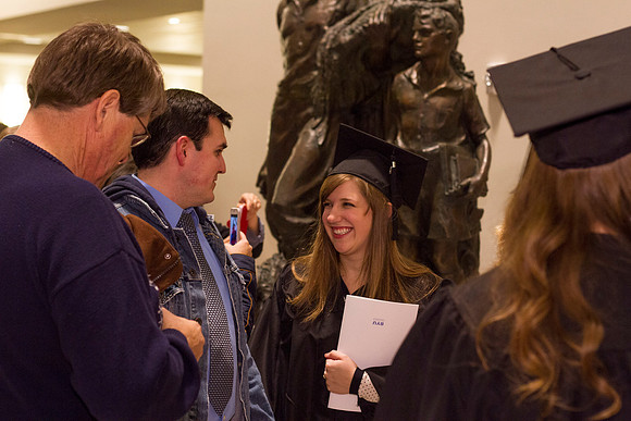 A student smiles outside the I-Center Auditorium.