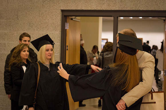A graduate takes a "selfie" with her husband after Commencemnt in the I-Center.