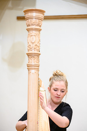 The harp ensemble performs in the recital hall in the Snow building.