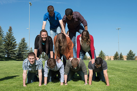 Student models interact and smile for marketing purposes that will be used for the new Campus Housing next to The Ivy.
