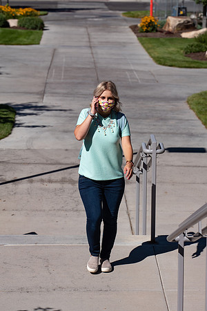 Examples of students staying safe and healthy during the COVID-19 pandemic by social distancing, following pathway arrows, and wearing face masks.