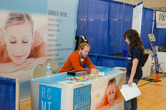BYU-Idaho students speak to representatives from colleges or companies from their field of study at a career fair held in the I-Center gym