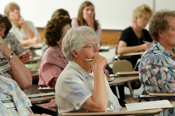 Education Week participants taking notes during class.