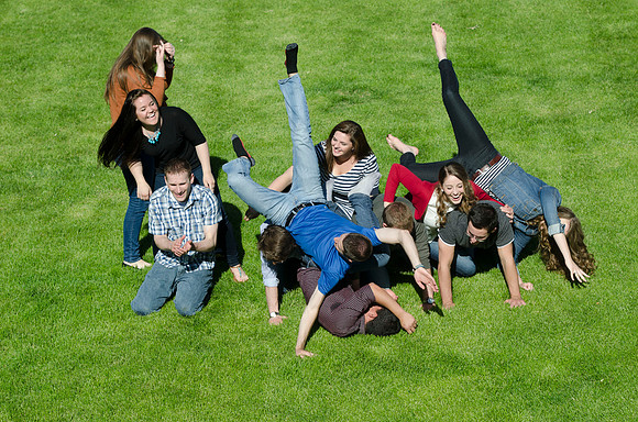 Students build and topple in a human pyramid.