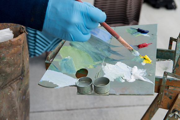 Brother Bodily prepares his paintbrush during a demonstration given outside the Spori Building.