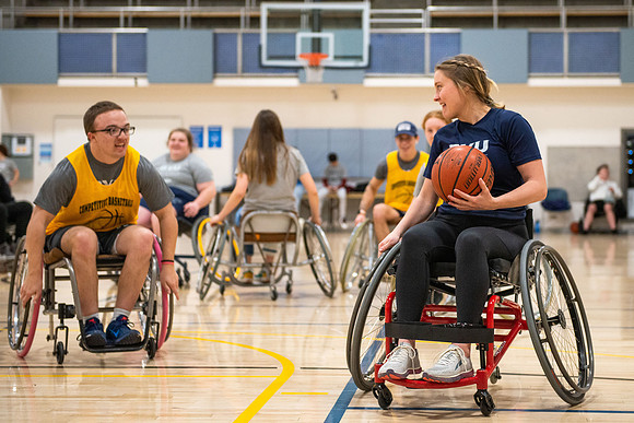 Students participate of Wheelchair Basketball in the Hart Gym.